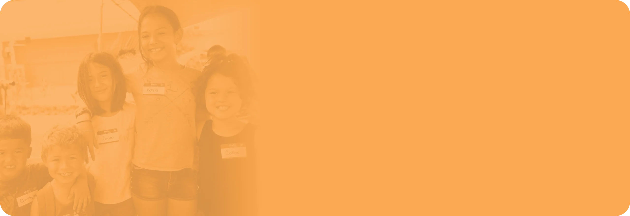 Three young kids of varying heights stand with arms around each other.